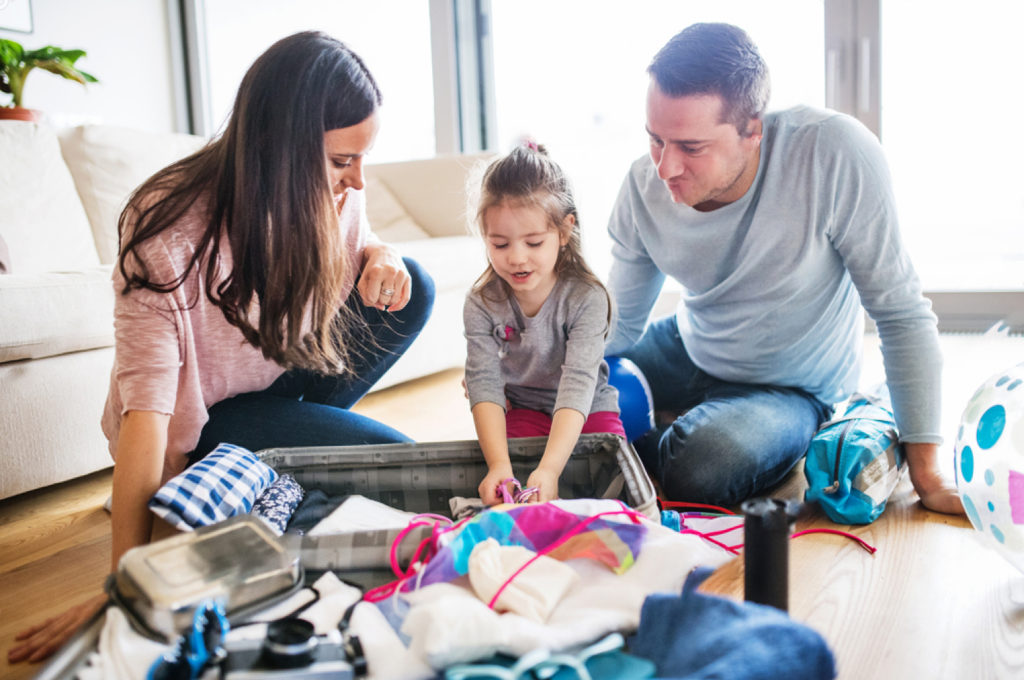 stock-photo-young-family-with-a-child-packing-for-holiday